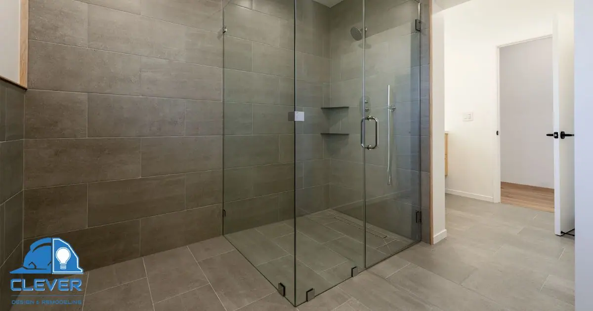 Large walk-in shower with frameless glass and dark porcelain tile