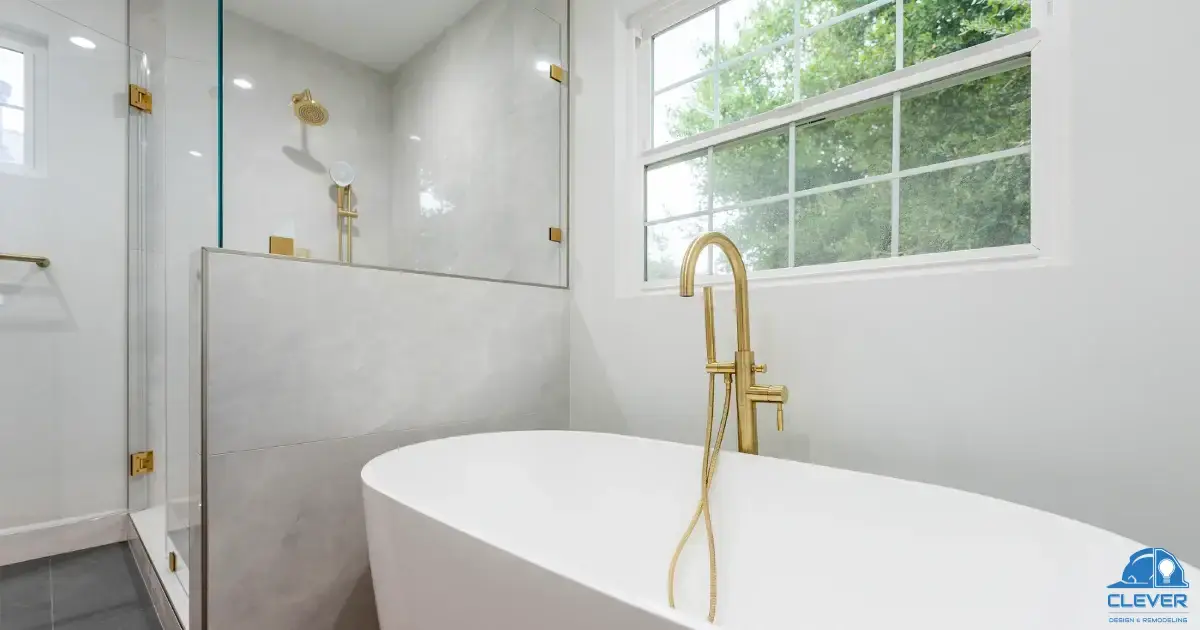 Marble and gold master bath with a freestanding tub