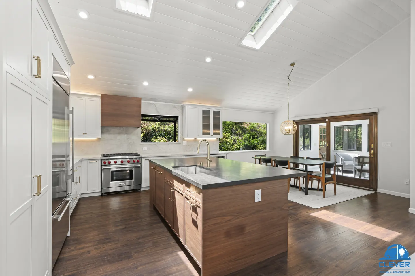 Open kitchen with a walnut island, white shaker cabinets and a vaulted white plank ceiling with skylights, kitchen and bath remodel in Los Gatos, CA