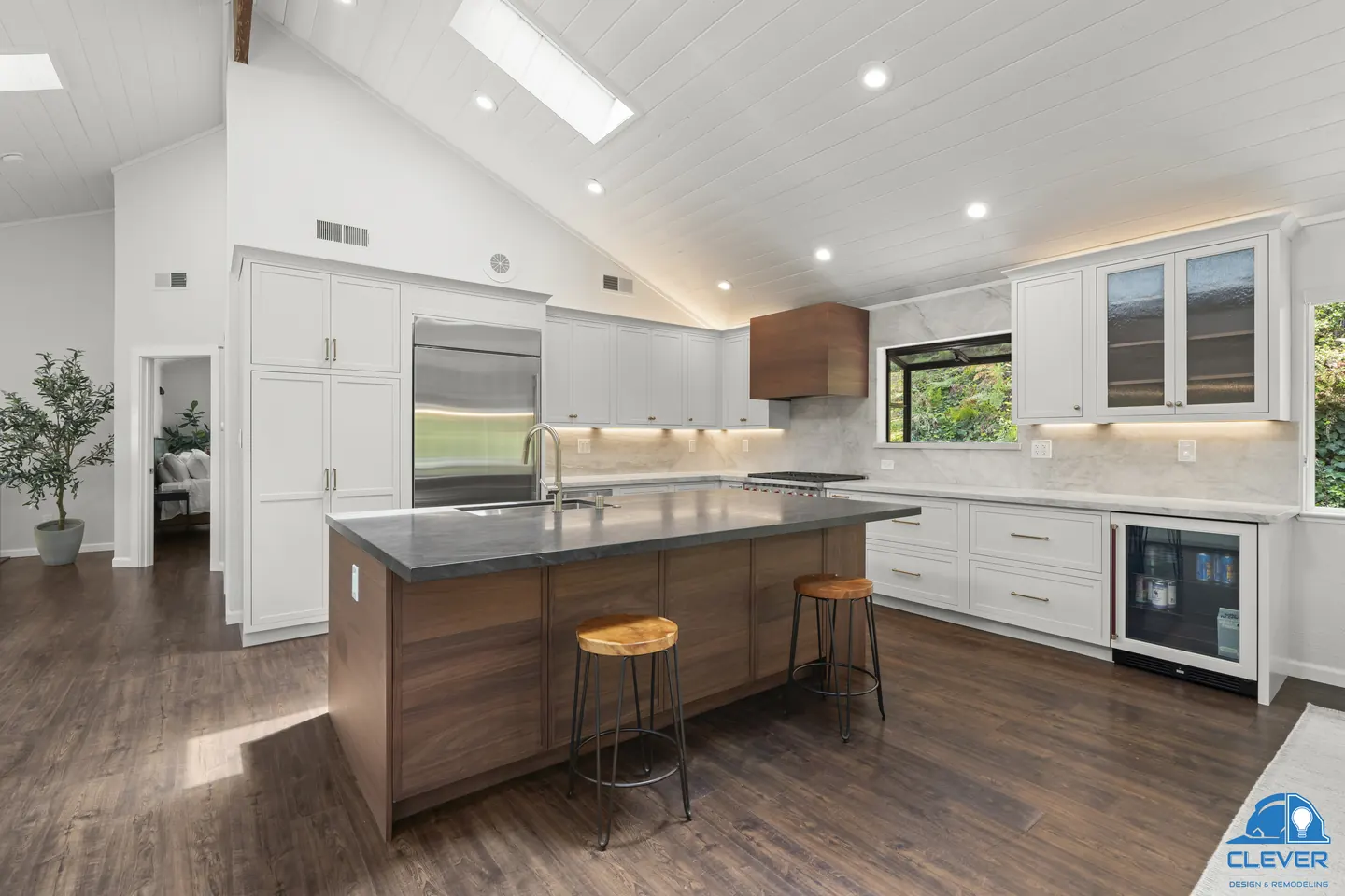 Kitchen with a walnut island and stools, a wine fridge and glass-front upper cabinets, kitchen and bath remodel in Los Gatos, CA