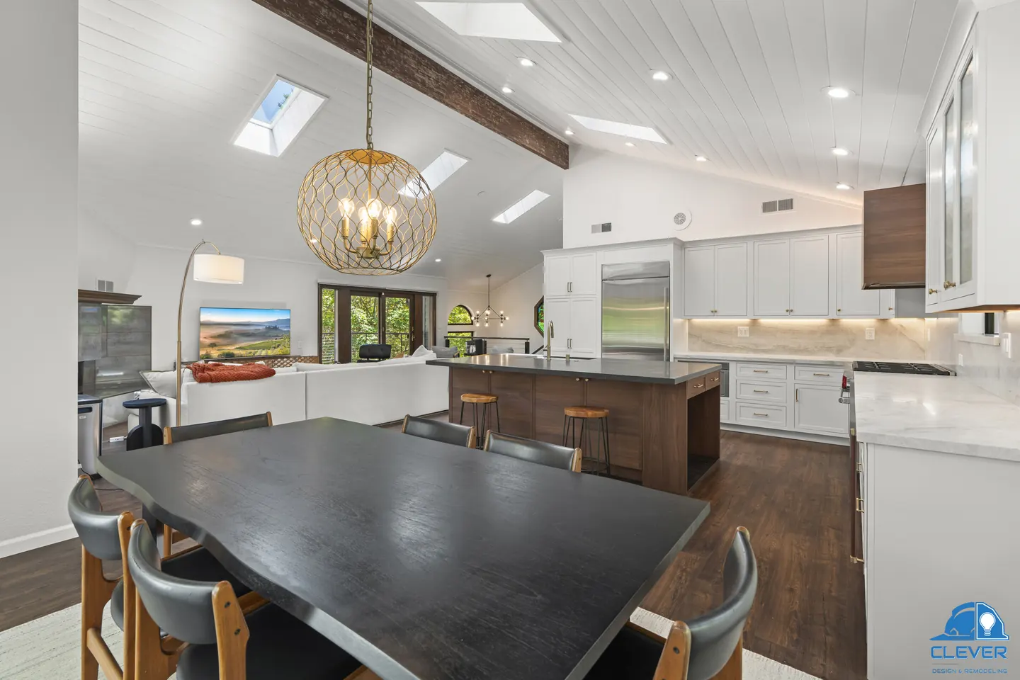 Dining table under a brass globe pendant, looking back to the kitchen and its skylights, kitchen and bath remodel in Los Gatos, CA