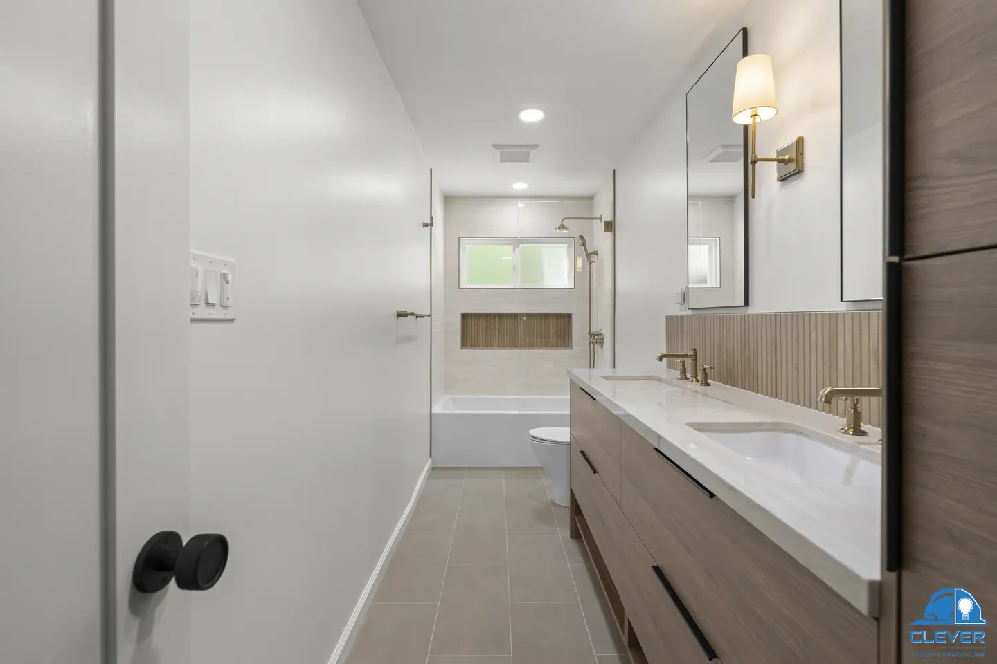 Long bathroom with a walnut vanity leading to a tiled tub-shower under a window, kitchen and bath remodel in Los Gatos, CA