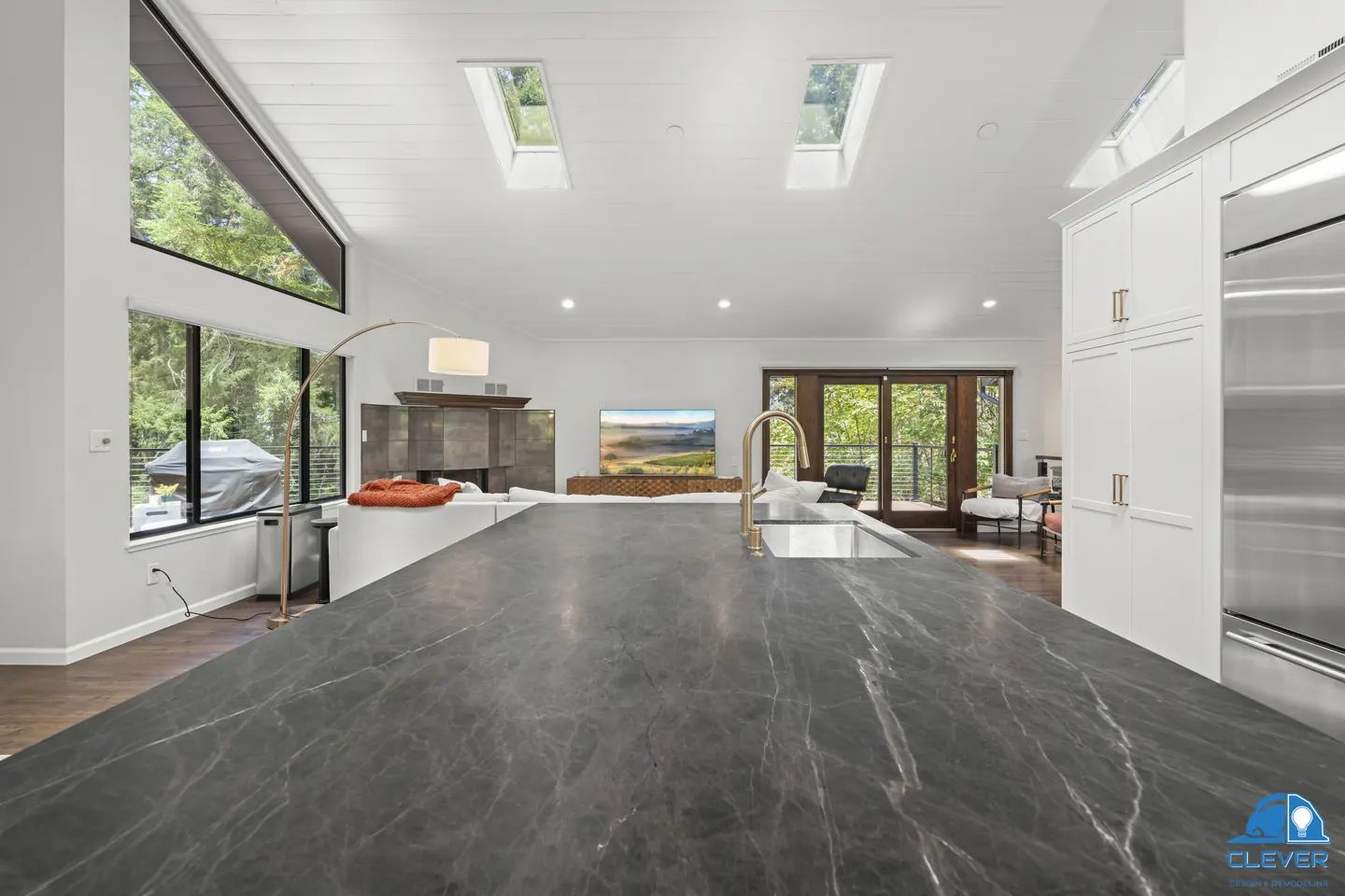 Dark veined stone island top looking out to the living room and deck, kitchen and bath remodel in Redwood City, CA