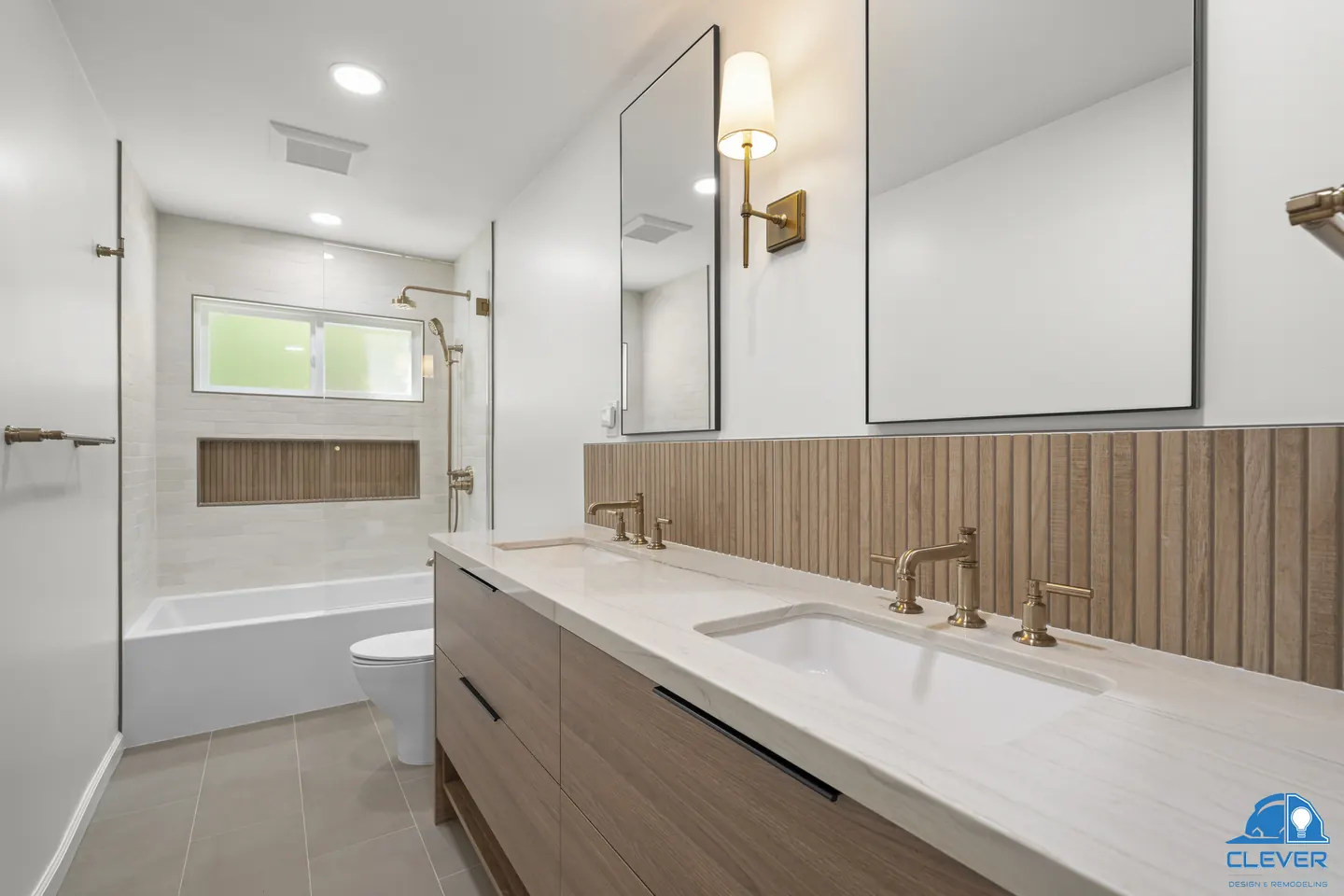Bathroom with a floating walnut double vanity, fluted wood-look tile and brass faucets and sconces, kitchen and bath remodel in Redwood City, CA