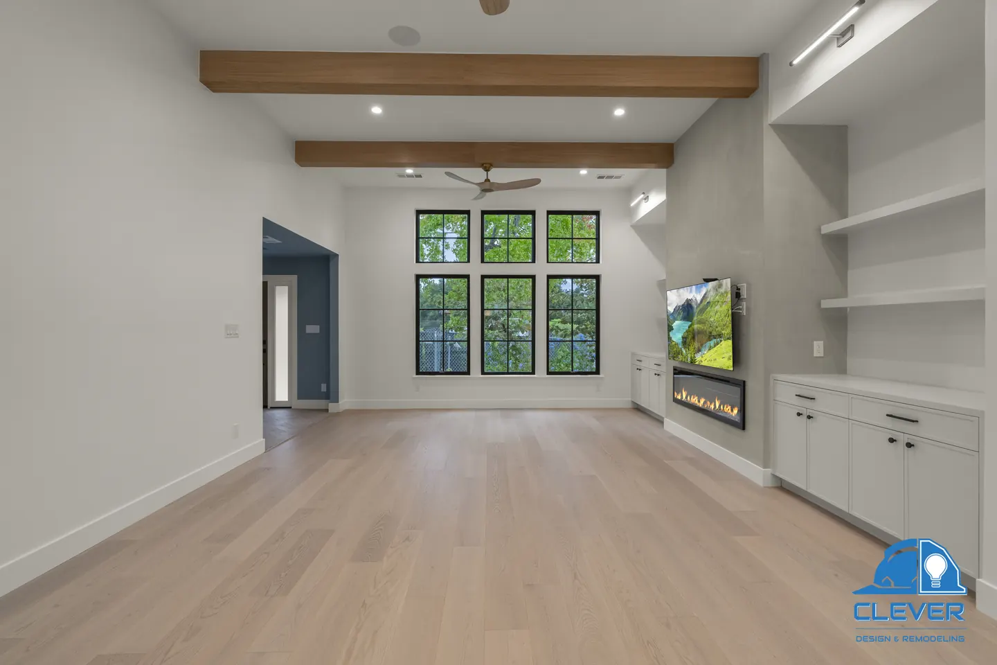 Living room with oak ceiling beams, a linear fireplace and built-in shelves and cabinets, whole-home remodel in Saratoga, CA
