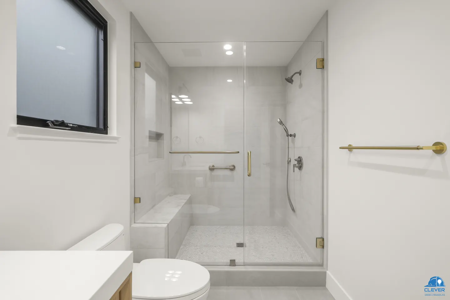 Glass shower with a tiled bench, niche and brass grab bar, whole-home remodel in Saratoga, CA